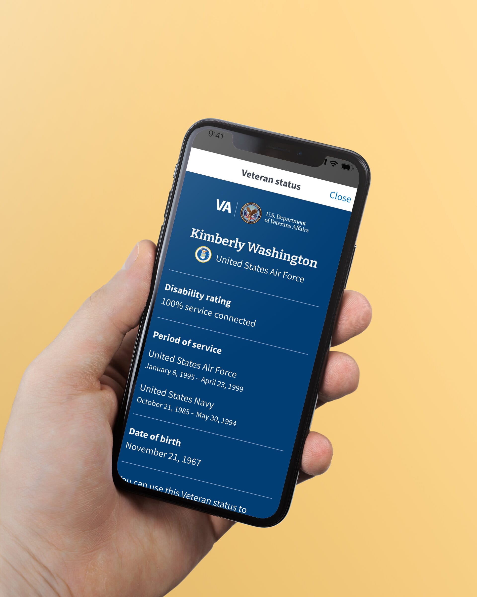 A hand holds an iPhone that is displaying the proof of Veteran status on the screen
